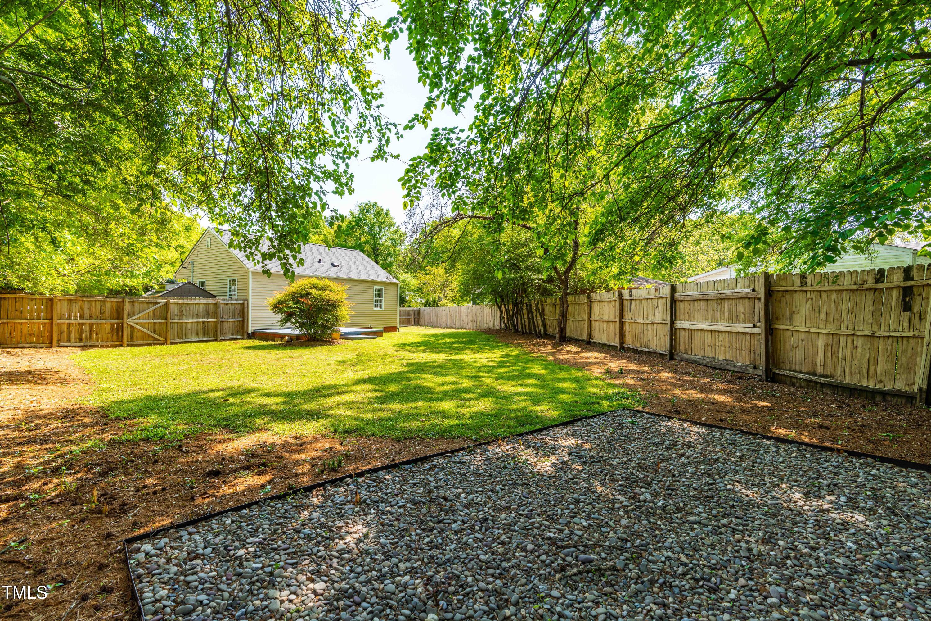 705 Hartford Road Raleigh, NC 27610 - Photo 19 of 24 a view of a yard with wooden fence