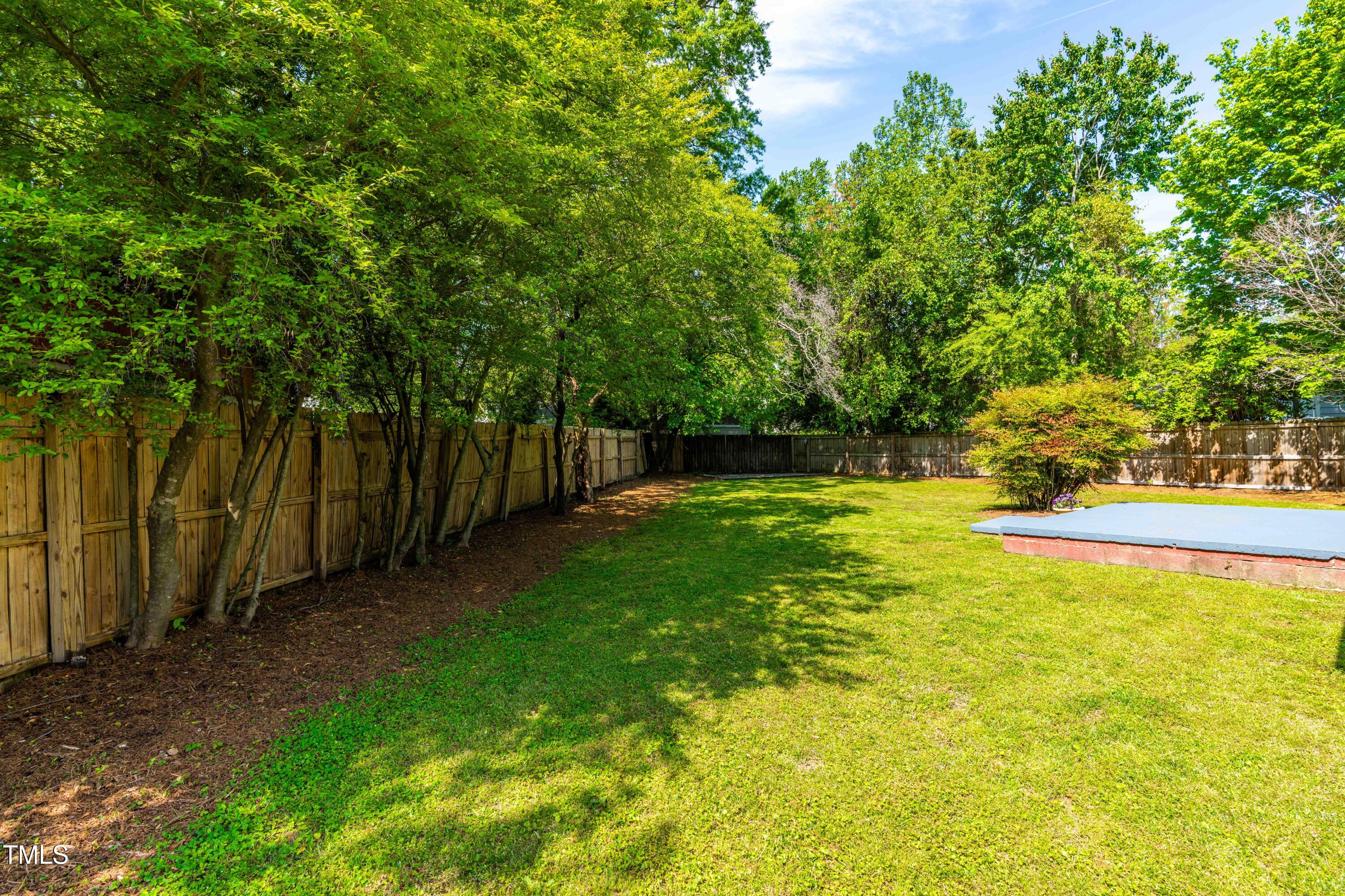 705 Hartford Road Raleigh, NC 27610 - Photo 20 of 24 a view of yard with swimming pool and trees in the background
