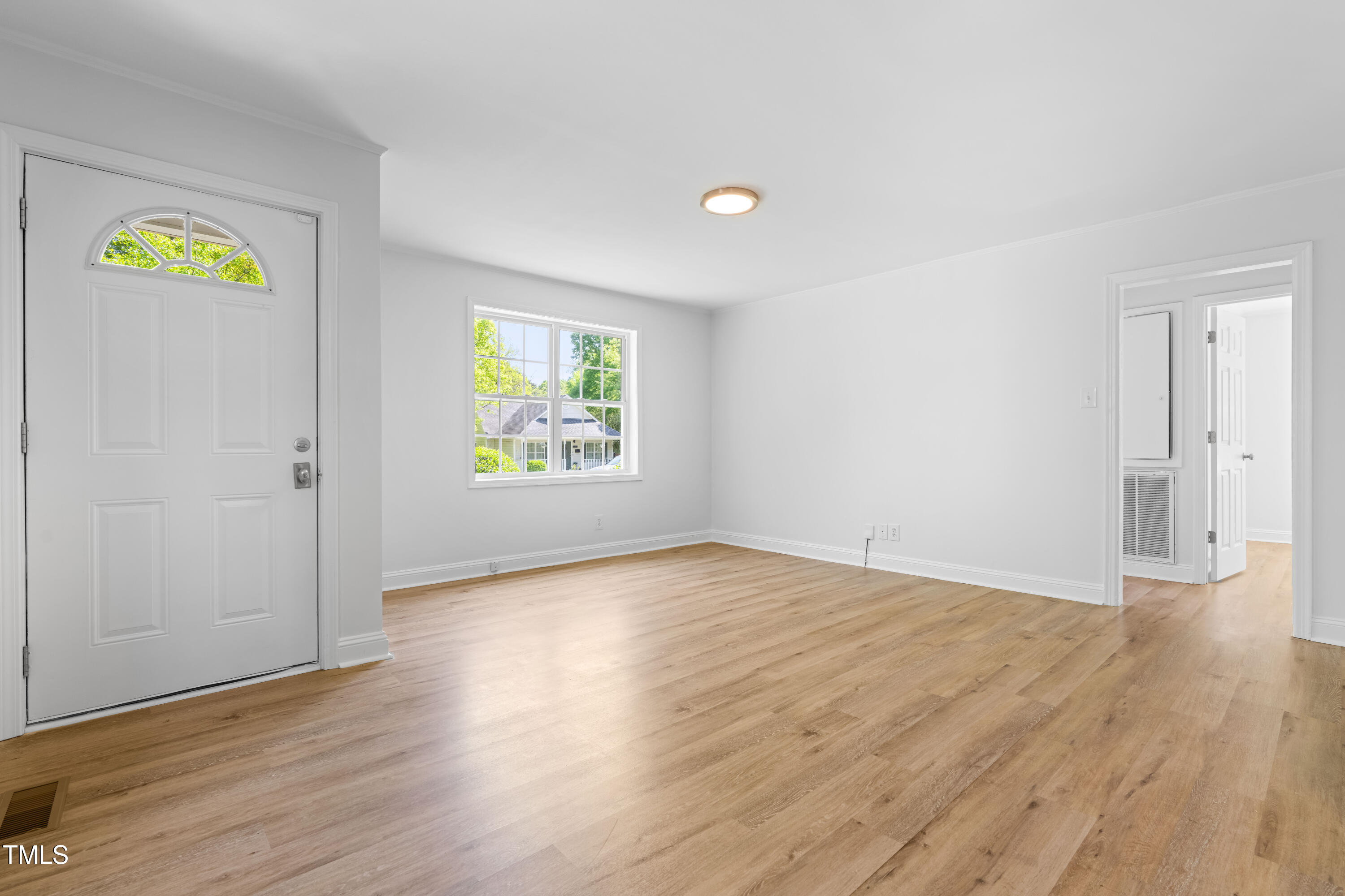 705 Hartford Road Raleigh, NC 27610 - Photo 7 of 24 an empty room with wooden floor and window