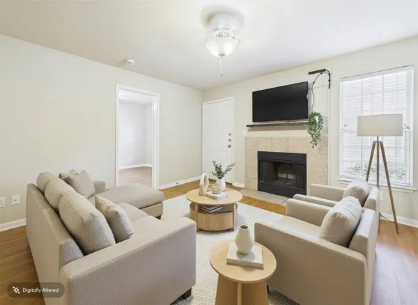 a living room with furniture a fireplace and a flat screen tv