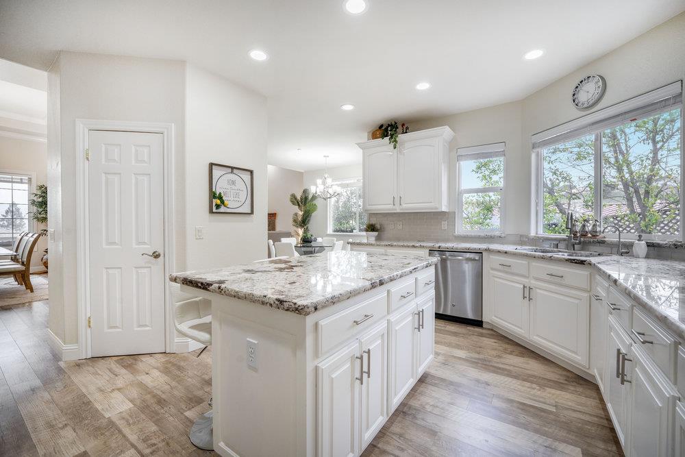 2360 Sunflower Circle Gilroy, CA 95020 - Photo 11 of 49 a kitchen with granite countertop kitchen island white cabinets and sink