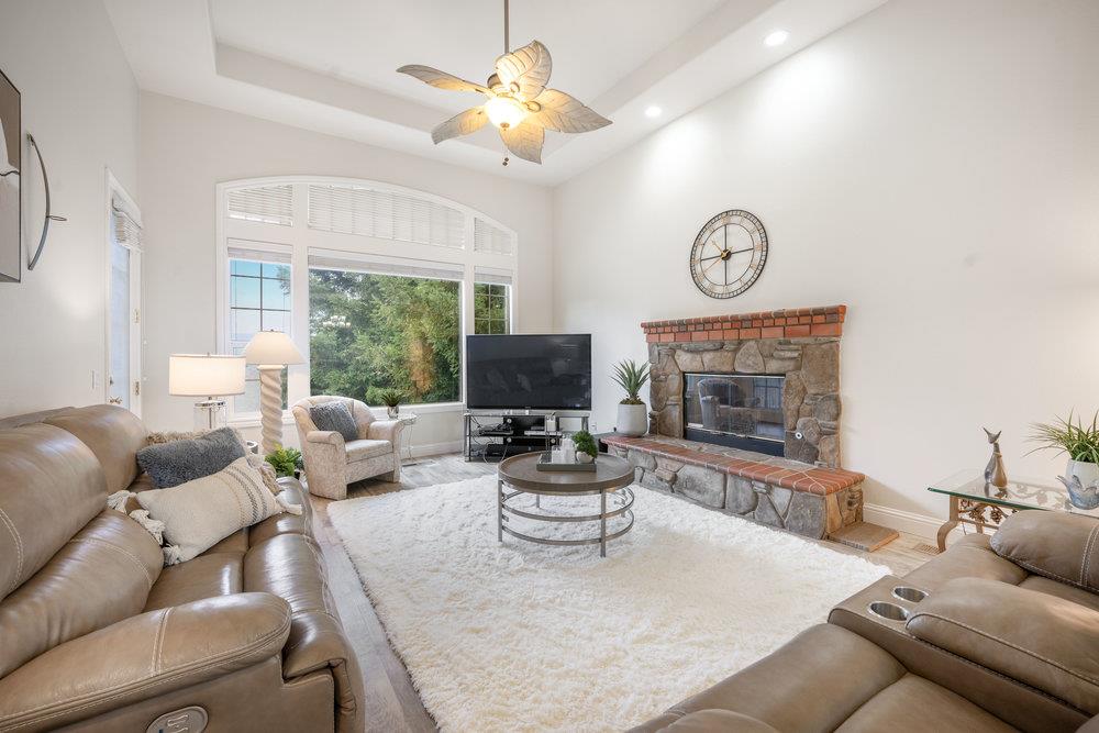 2360 Sunflower Circle Gilroy, CA 95020 - Photo 15 of 49 a living room with furniture a large window and a fireplace