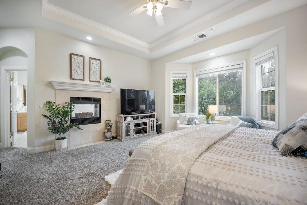 2360 Sunflower Circle Gilroy, CA 95020 - Photo 19 of 49 a bedroom with a bed a large window and a flat tv screen