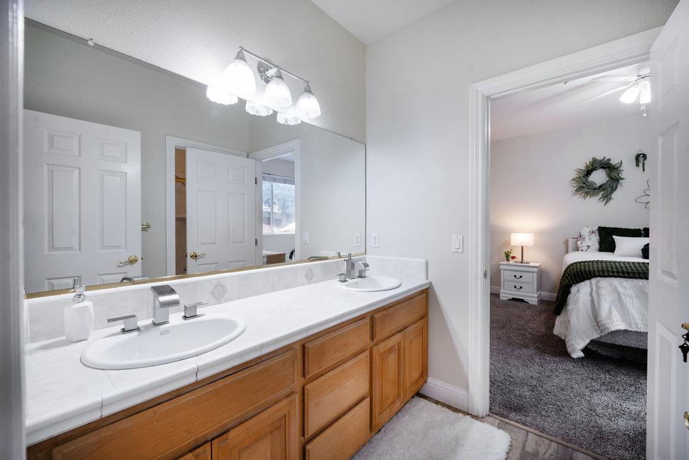 2360 Sunflower Circle Gilroy, CA 95020 - Photo 24 of 49 a en suite bathroom with a double vanity sink and a mirror