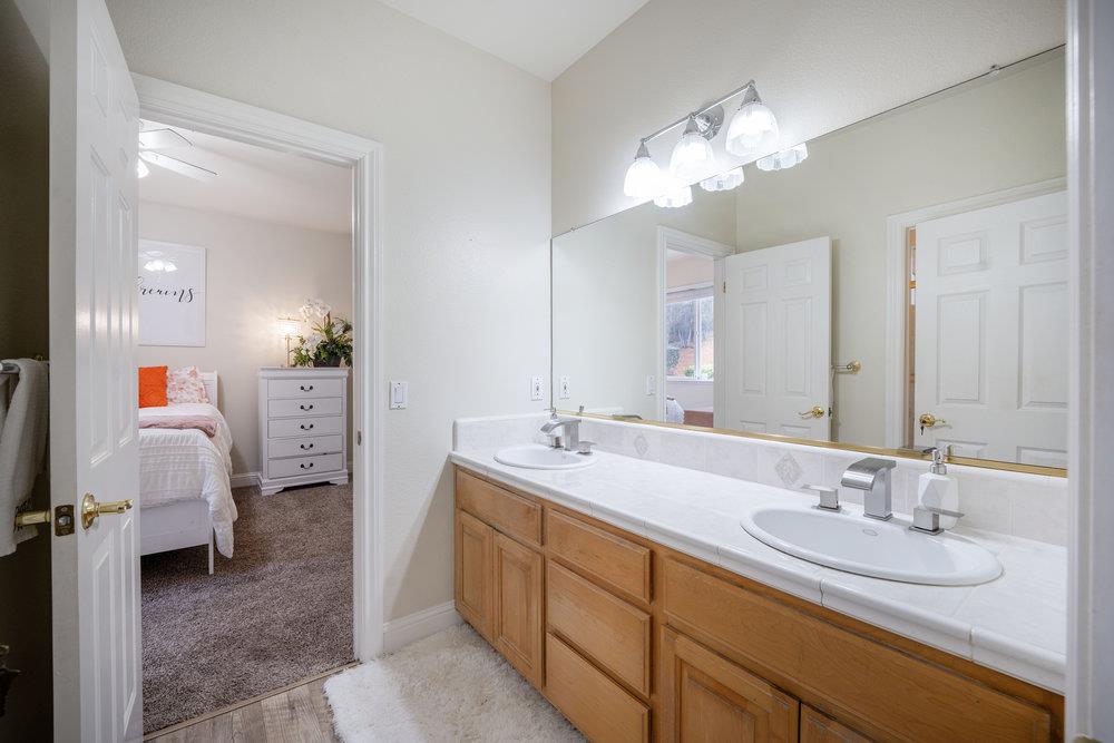 2360 Sunflower Circle Gilroy, CA 95020 - Photo 25 of 49 a en suite bathroom with a double vanity sink and a mirror