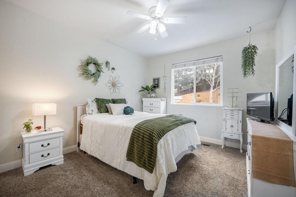 2360 Sunflower Circle Gilroy, CA 95020 - Photo 27 of 49 a spacious bedroom with a bed and a chandelier fan