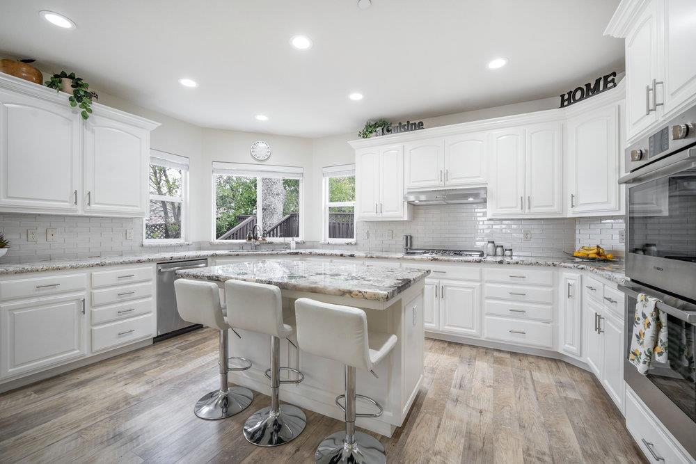 2360 Sunflower Circle Gilroy, CA 95020 - Photo 10 of 49 a kitchen with granite countertop white cabinets and white appliances