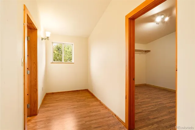 a view of walk in closet with wooden floor