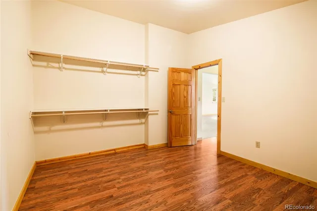 a view of a room with wooden floor