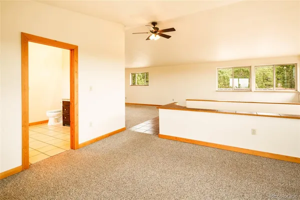 an empty room with wooden floor and a window