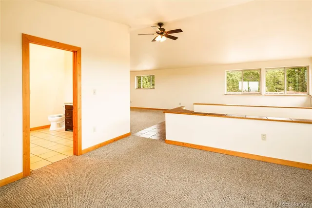 an empty room with wooden floor and a window