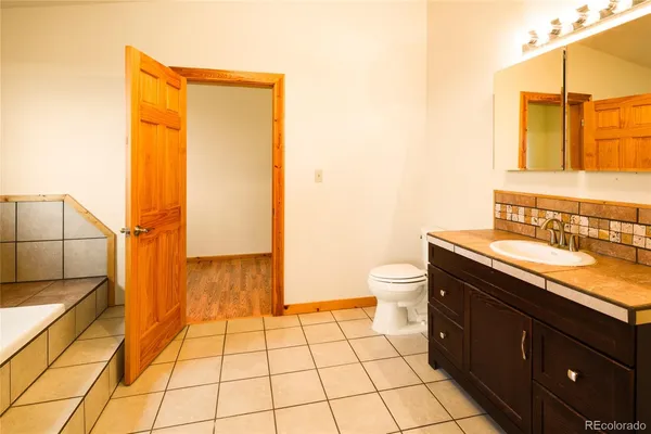 a bathroom with a bathtub and next to a window
