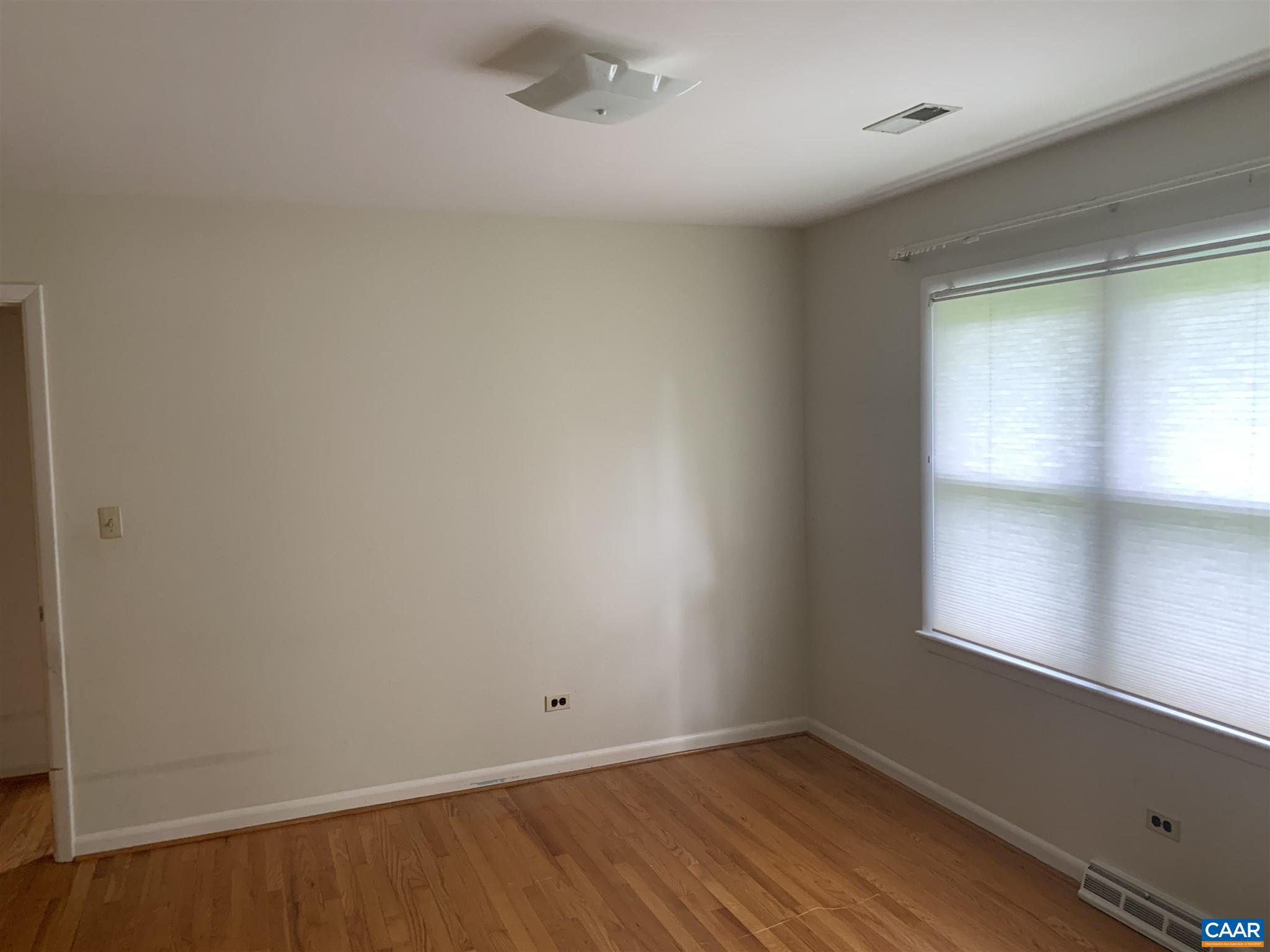 2701 Northfield Road Charlottesville, VA 22901 - Photo 14 of 30 an empty room with wooden floor and windows