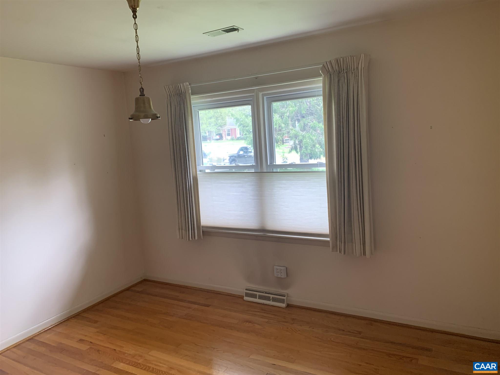 2701 Northfield Road Charlottesville, VA 22901 - Photo 16 of 30 an empty room with wooden floor and windows