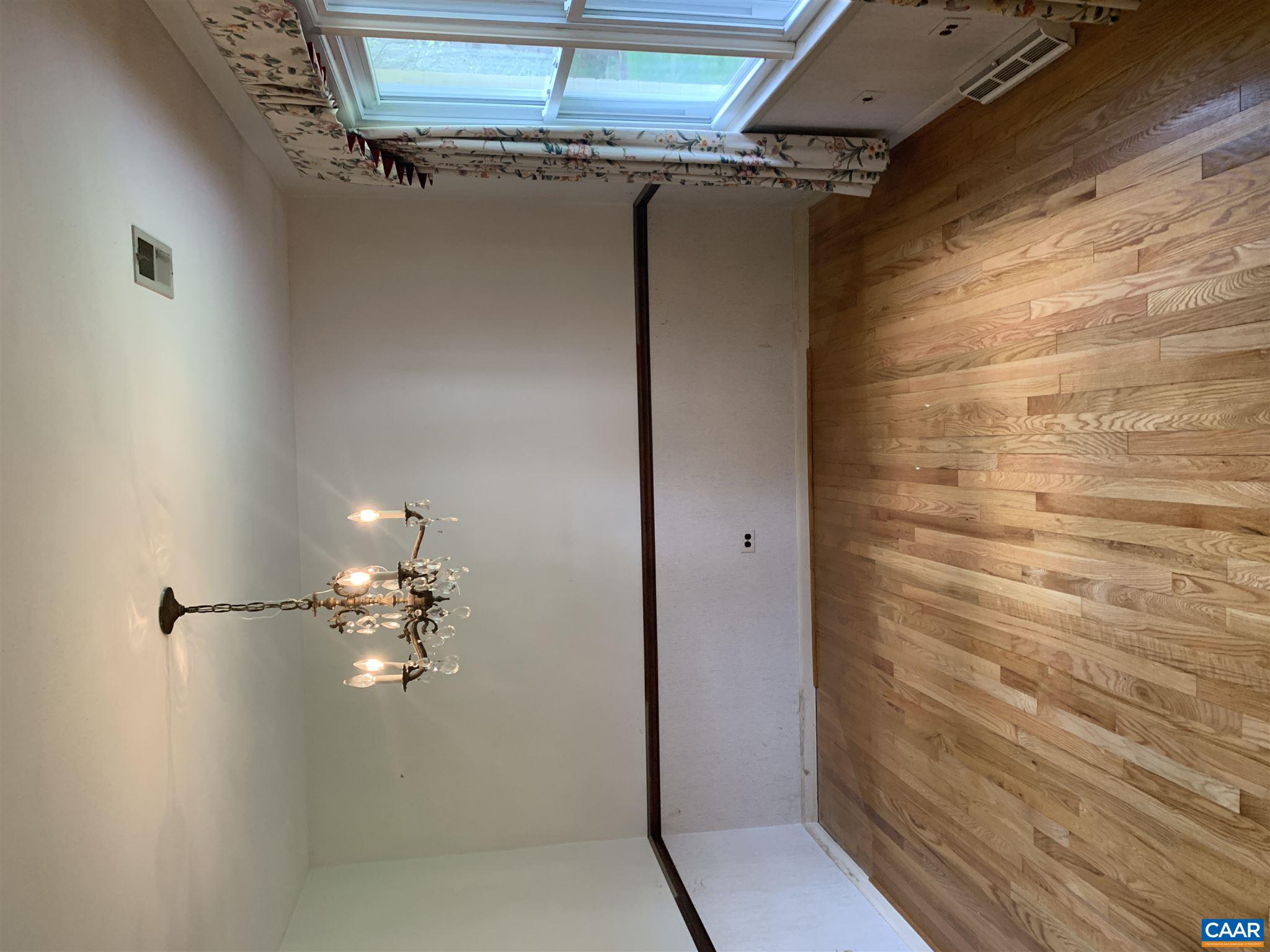 2701 Northfield Road Charlottesville, VA 22901 - Photo 4 of 30 a view of a room with wooden floors and chandelier