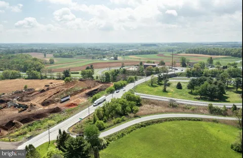 an aerial view of a city with lots of residential buildings and ocean view