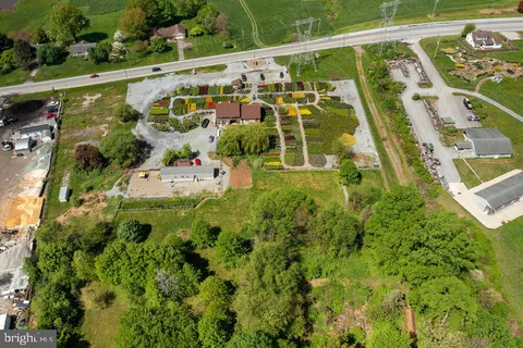 a view of swimming pool with a yard and potted plants