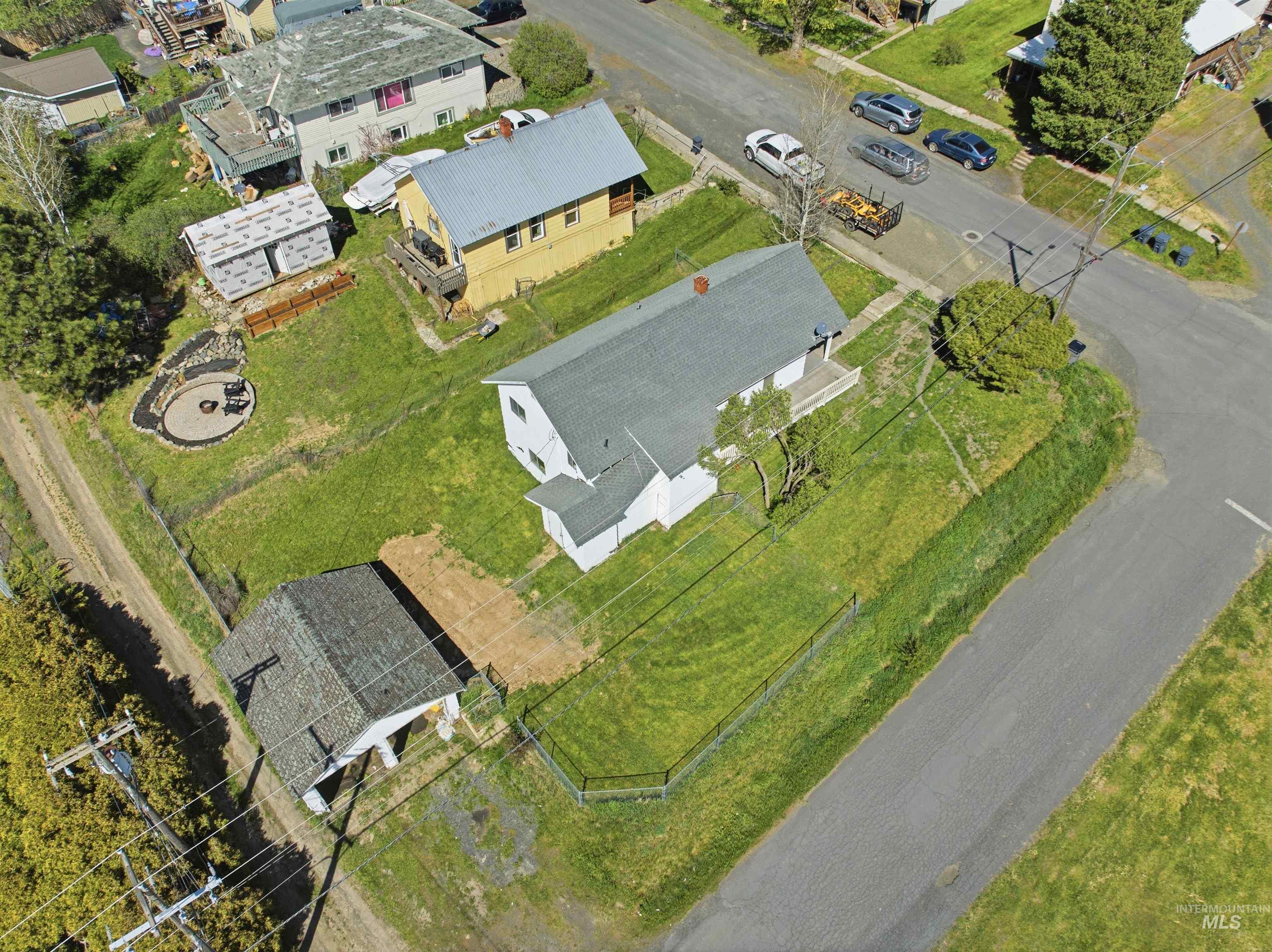 810 Pine Street Potlatch, ID 83855 - Photo 29 of 33 Aerial view showcasing a corner lot with a white main residence and a detached garage structure