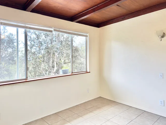 a view of open kitchen with granite countertop sink and cabinets