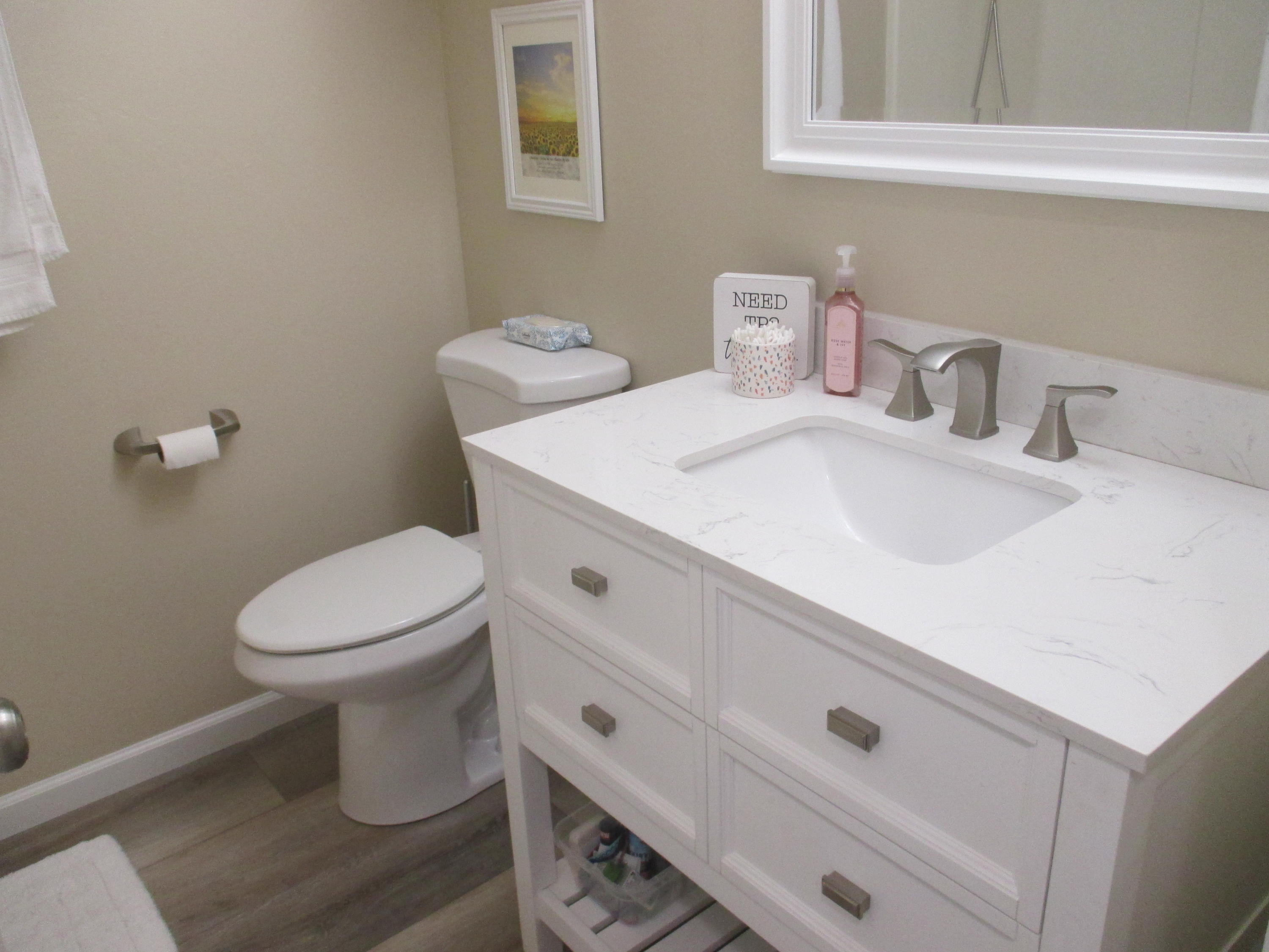 21908 Mariposa Road Tehachapi, CA 93561 - Photo 11 of 23 a white toilet sitting next to a bathroom sink
