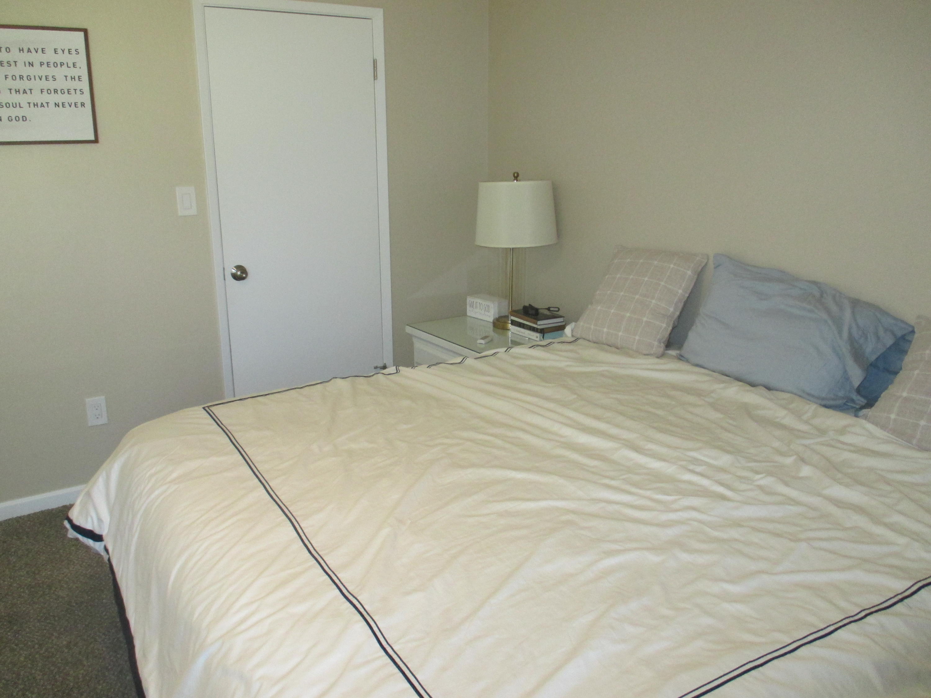 21908 Mariposa Road Tehachapi, CA 93561 - Photo 13 of 23 a large bed sitting in a bedroom next to a lamp