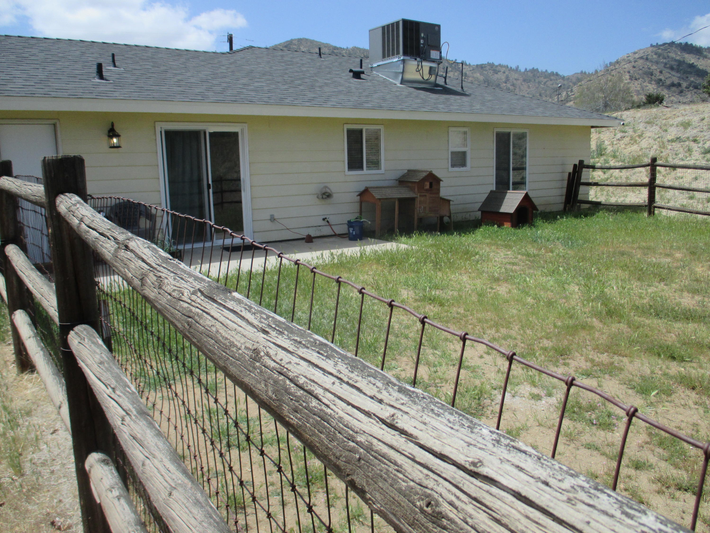 21908 Mariposa Road Tehachapi, CA 93561 - Photo 20 of 23 a view of a house with backyard and sitting area