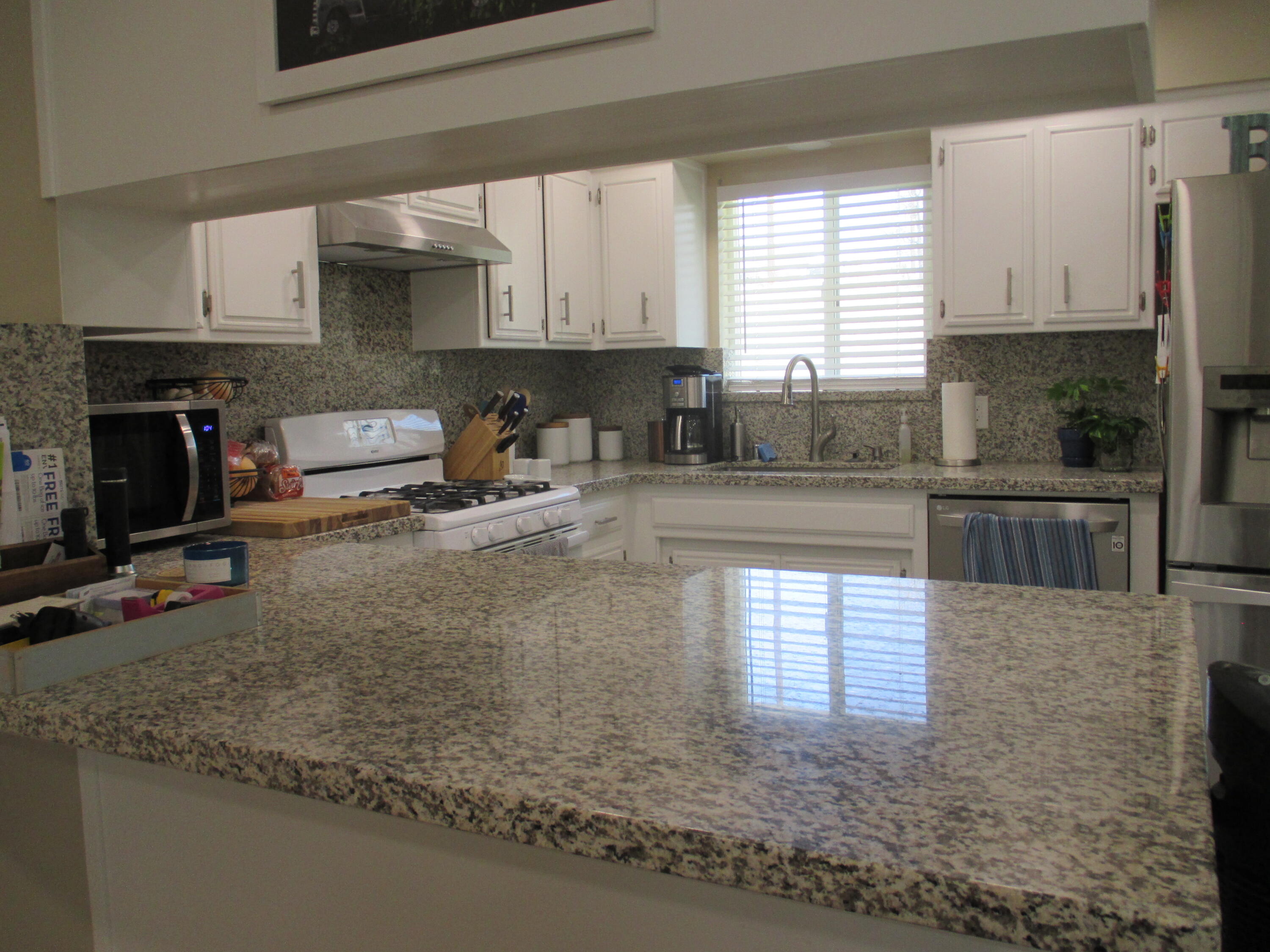 21908 Mariposa Road Tehachapi, CA 93561 - Photo 3 of 23 a kitchen with stainless steel appliances granite countertop a sink stove and cabinets