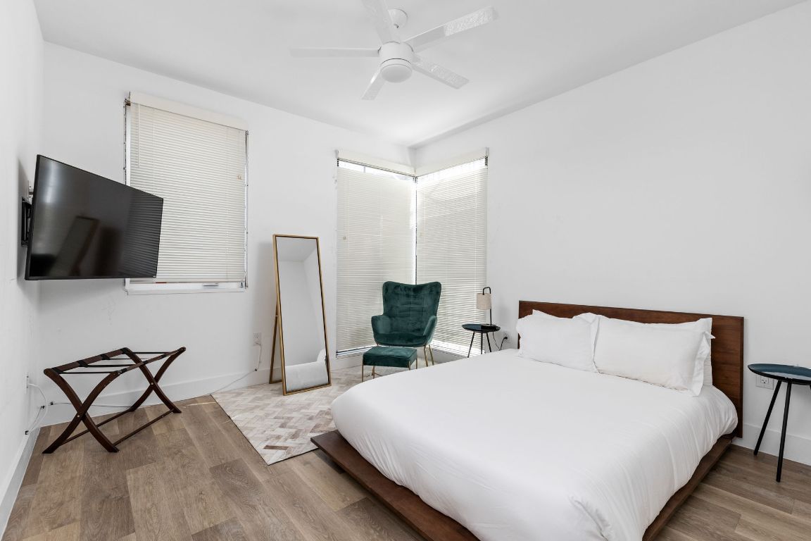 2709 East 5th Street, Unit 1306 Austin, TX 78702 - Photo 15 of 26 Primary bedroom with generous windows, a modern ceiling fan, and natural light.