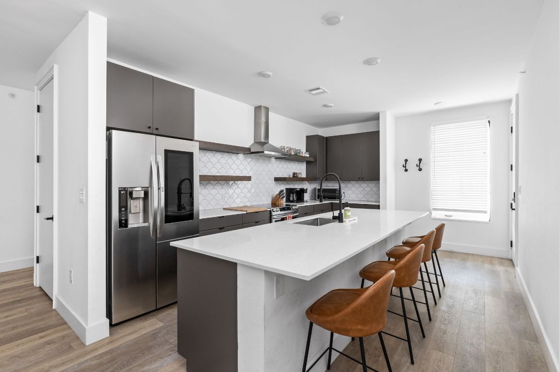 2709 East 5th Street, Unit 1306 Austin, TX 78702 - Photo 3 of 26 Floating wood shelves add warmth and visual interest.