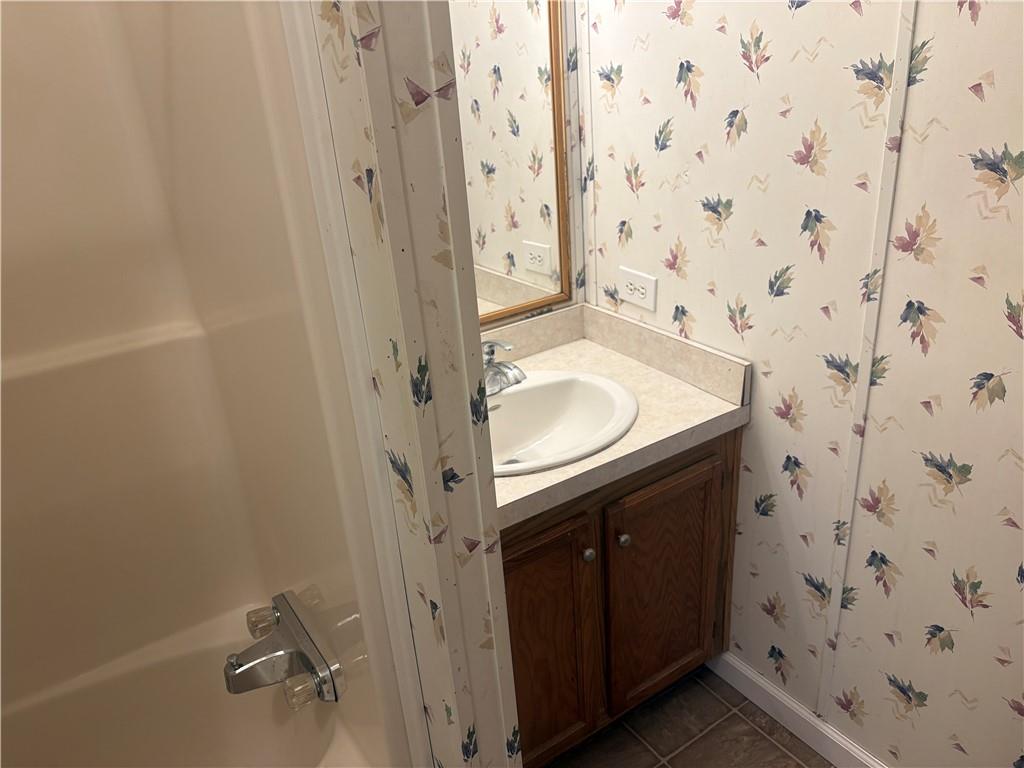 903 Union Street Farrell, PA 16121 - Photo 17 of 29 a bathroom with a granite countertop sink and a mirror