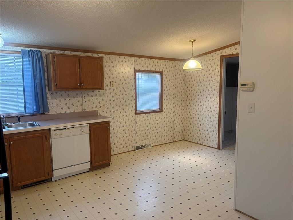 903 Union Street Farrell, PA 16121 - Photo 10 of 29 a kitchen with a stove a sink and a refrigerator
