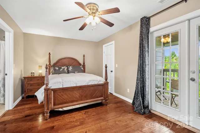 a bathroom with a granite countertop sink toilet and mirror