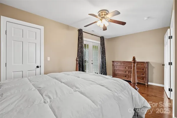 a bedroom with a large bed and a chandelier