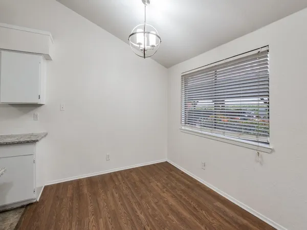 a view of a room with wooden floor and windows