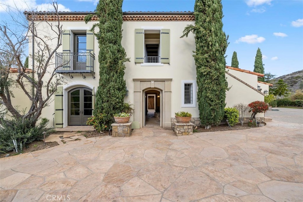 63 Vernal Spring Irvine, CA 92603 - Photo 1 of 1 a view of a house with potted plants and a large tree