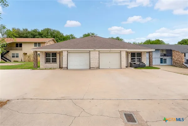 a house that has a tree in front of it