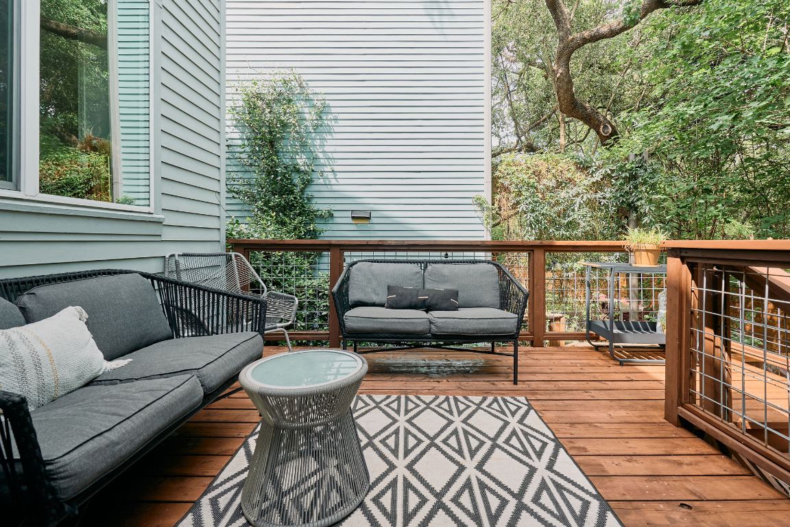 3001 Del Curto Road, Unit 14 Austin, TX 78704 - Photo 12 of 18 a balcony with furniture and wooden floor