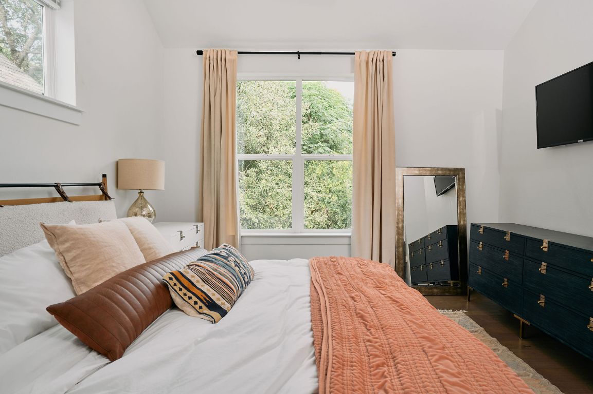 3001 Del Curto Road, Unit 14 Austin, TX 78704 - Photo 9 of 18 a bedroom with a bed and a flat tv screen on dresser