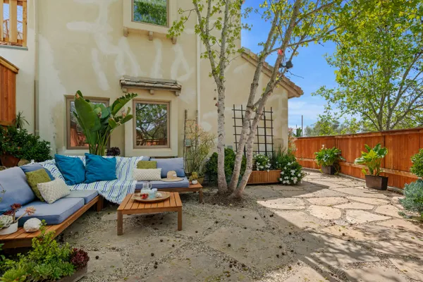 a view of a patio with couches and potted plants