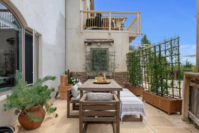 a table and chairs in front of a house