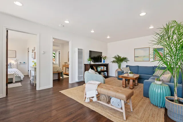 a living room with furniture a wooden floor and a table