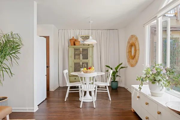 a view of a dining room with furniture and wooden floor