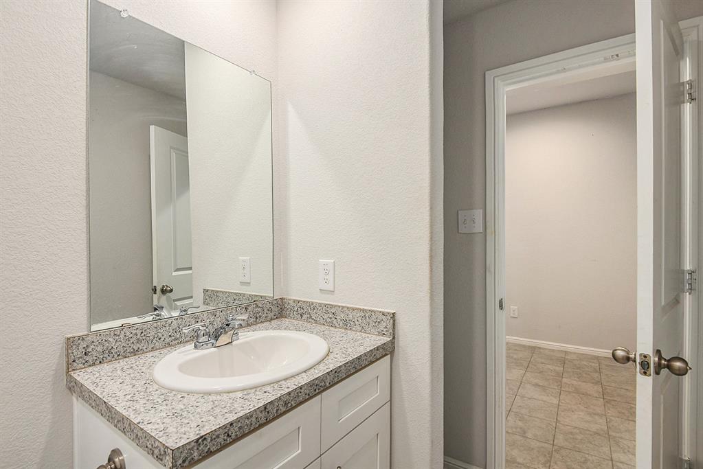 805 Durango Lane Cleburne, TX 76033 - Photo 17 of 23 a bathroom with a granite countertop sink and a mirror