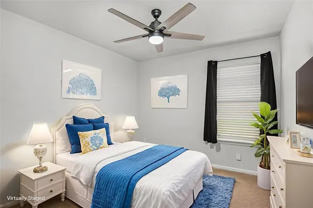 a bedroom with bed and a chandelier