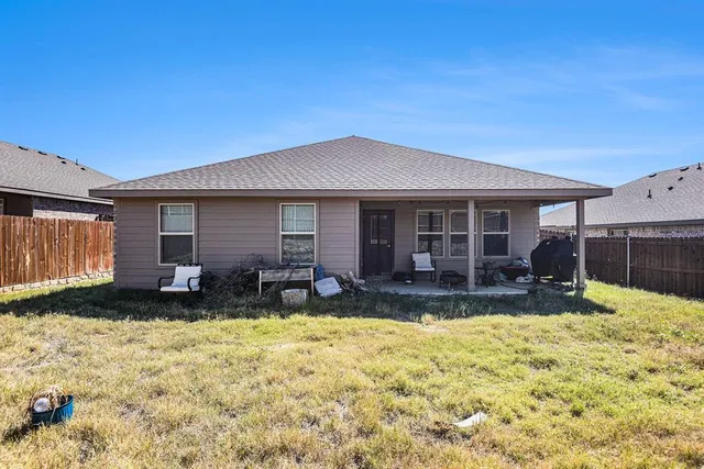 a house view with a sitting space and garden