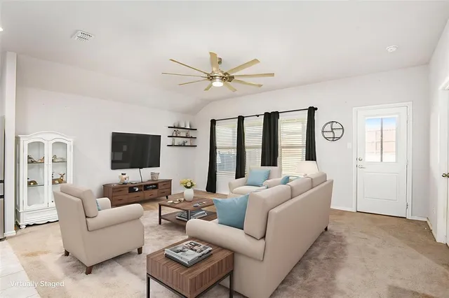 a living room with furniture and a flat screen tv