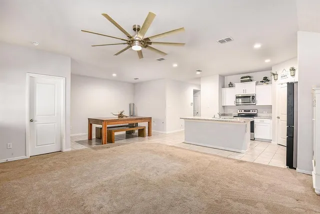 a view of kitchen with sink microwave and refrigerator