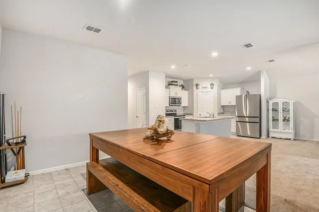 a room with kitchen island a sink and a stove