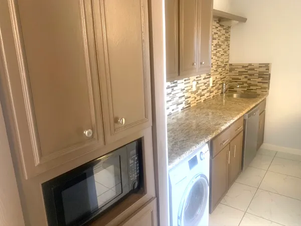 a view of open kitchen cabinets and window