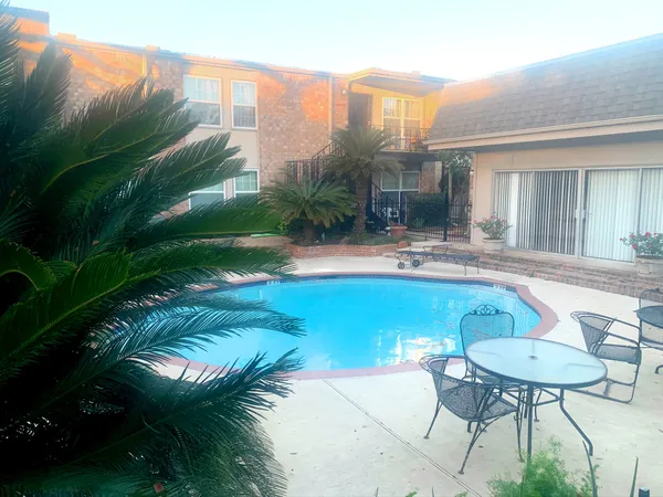 a swimming pool with outdoor seating and yard